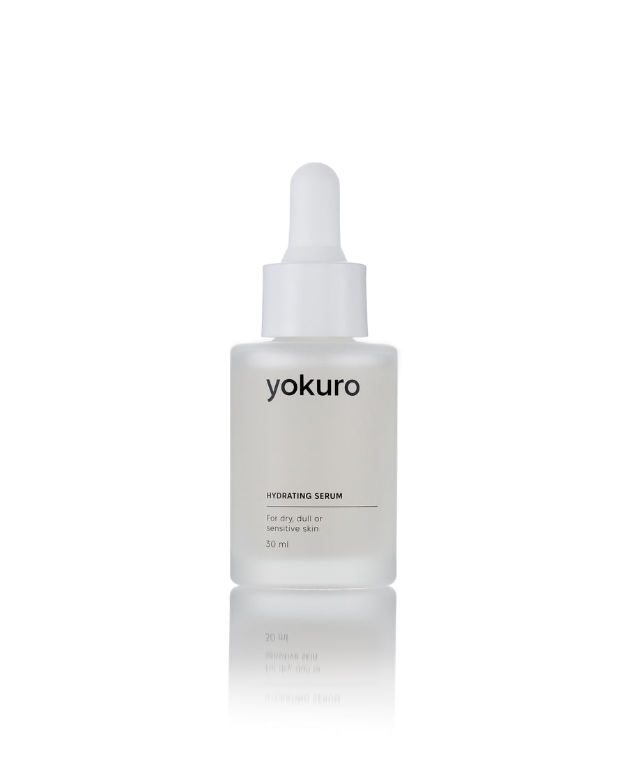 A 30 ml dropper bottle of yokuro Hydrating Serum, featuring a frosted glass bottle and a white plastic dropper cap, centered on a reflective white surface.