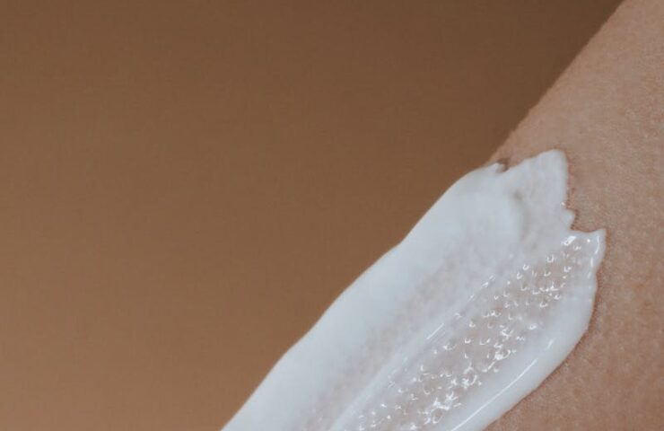 A detailed view of moisturizing cream applied on smooth human skin.