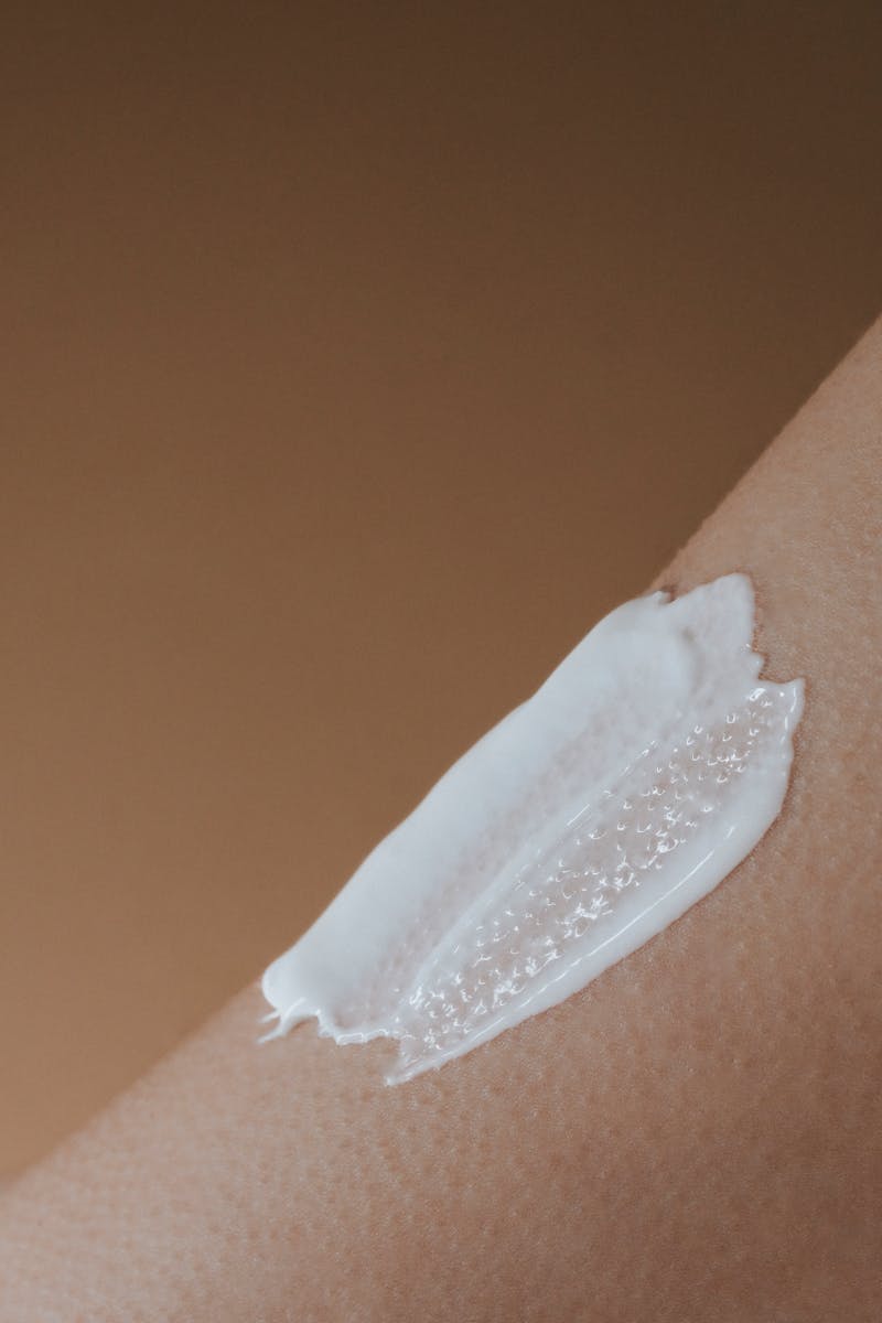 A detailed view of moisturizing cream applied on smooth human skin.