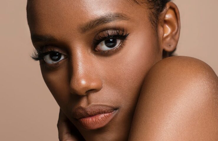 Stunning close-up portrait of a black woman with expressive eyes in a studio setting.